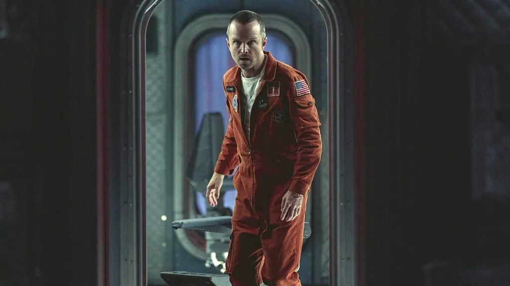 Aaron Paul in Black Mirror wearing orange jumpsuit
