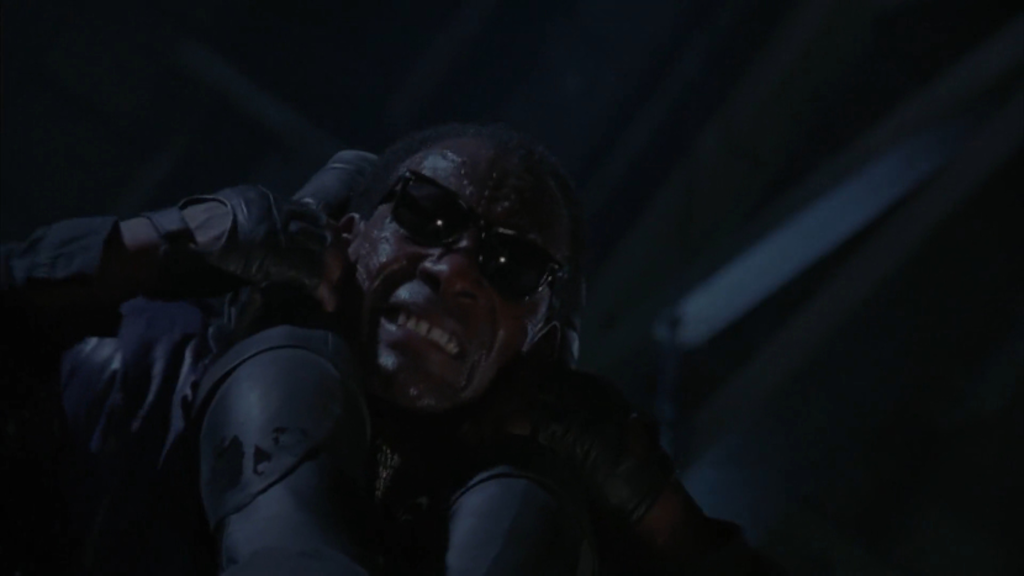 Batman throws Joker's henchman down Belltower