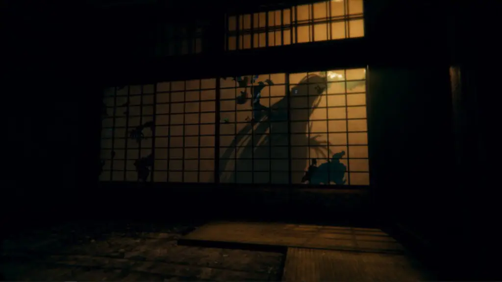 A dark room with a shadow walking past the shoji sliding door, visible from the light in the corridor outside the room