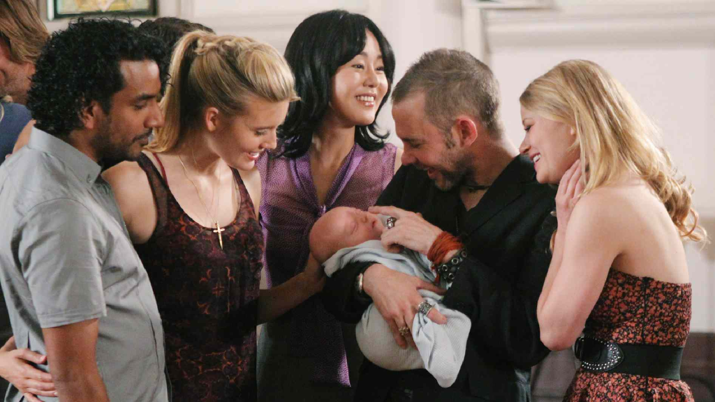 The cast of Lost holding a baby in the series finale