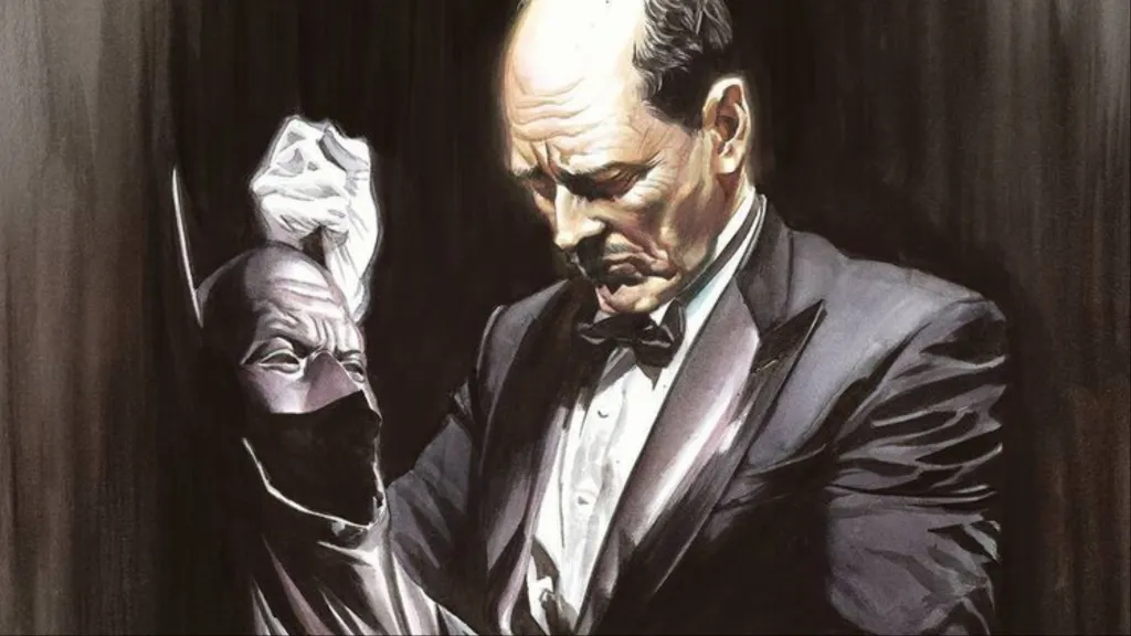 Alfred holding Batman's cowl mournfully