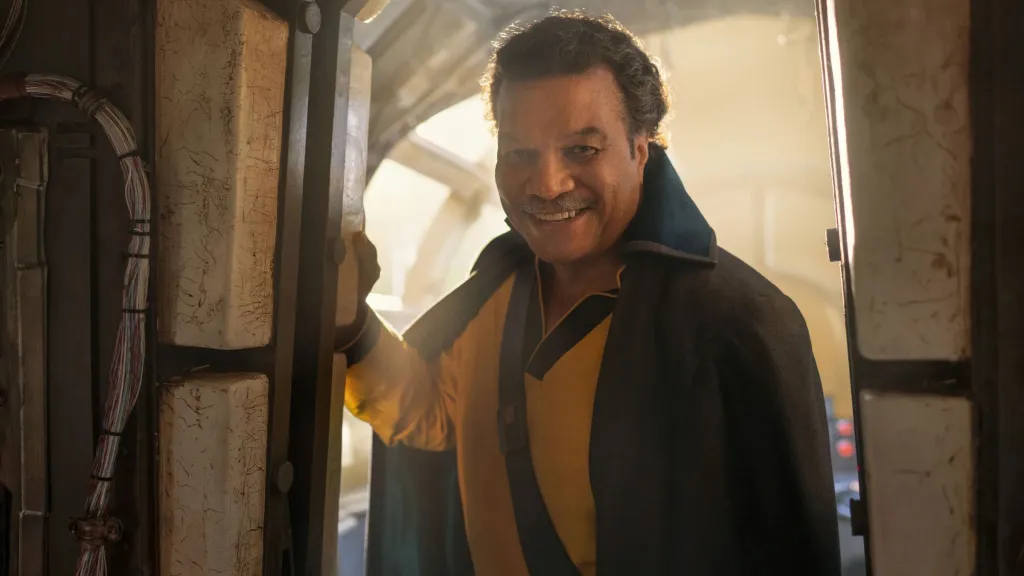 Lando Calrissian smiling in the Millennium Falcon in The Rise of Skywalker.