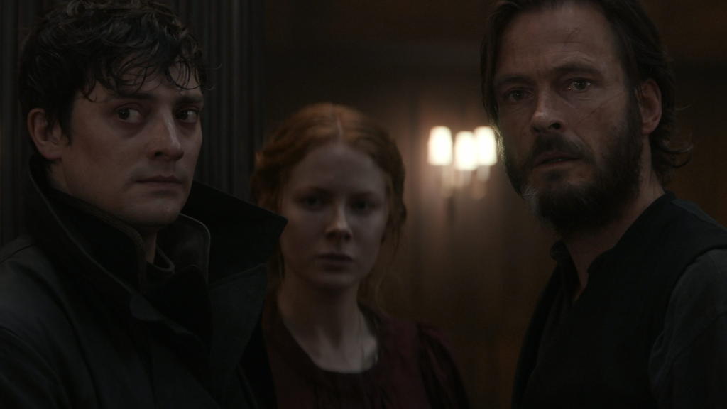 The cast of 1899 stood in a shadowy hallway