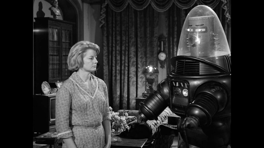 A woman stood beside the robot Uncle Simon in The Twilight Zone