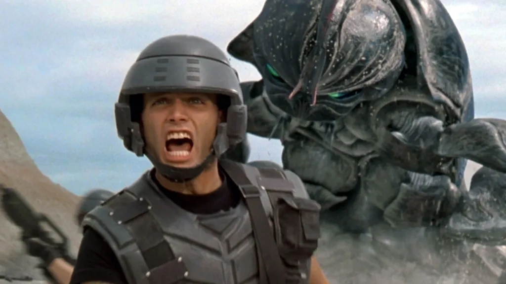 A soldier running from a bug in Starship Troopers