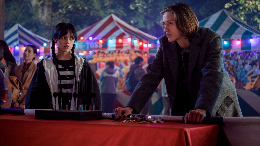 Wednesday (Jenna Ortega) and Xavier (Percy Hynes White) at the carnival in Wednesday season 1