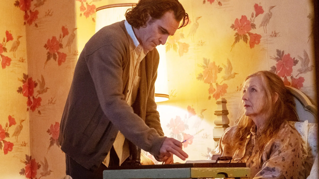 Joaquin Phoenix as Arthur Fleck caring for his mother Penny in Joker (2019)