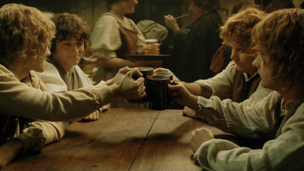 Frodo, Sam, Merry, and Pippin sharing a drink in The Lord of the Rings: The Return of the King