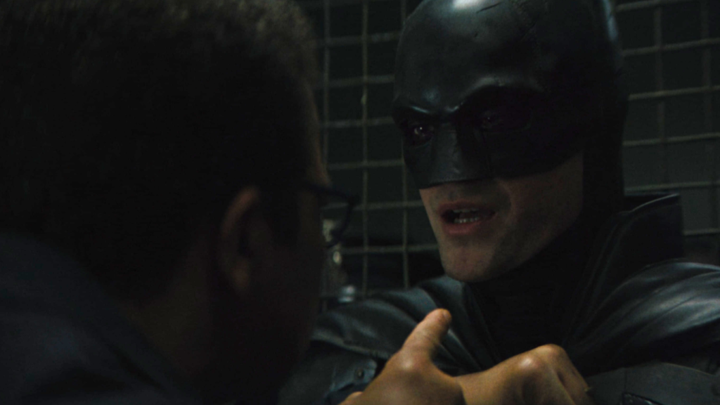 Robert Pattinson as Batman in the GCPD in The Batman (2022)