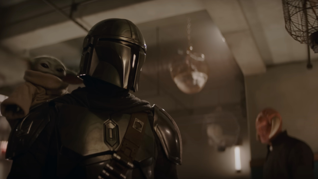 The Mandalorian and Grogu with an Iktotchi in the background