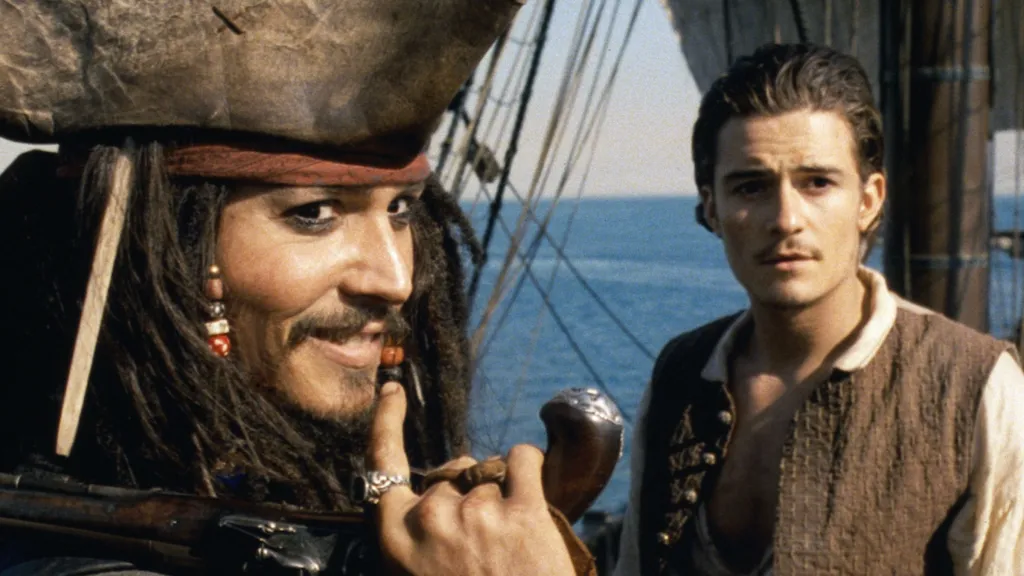 Jack Sparrow smirking in front of Will Turner.