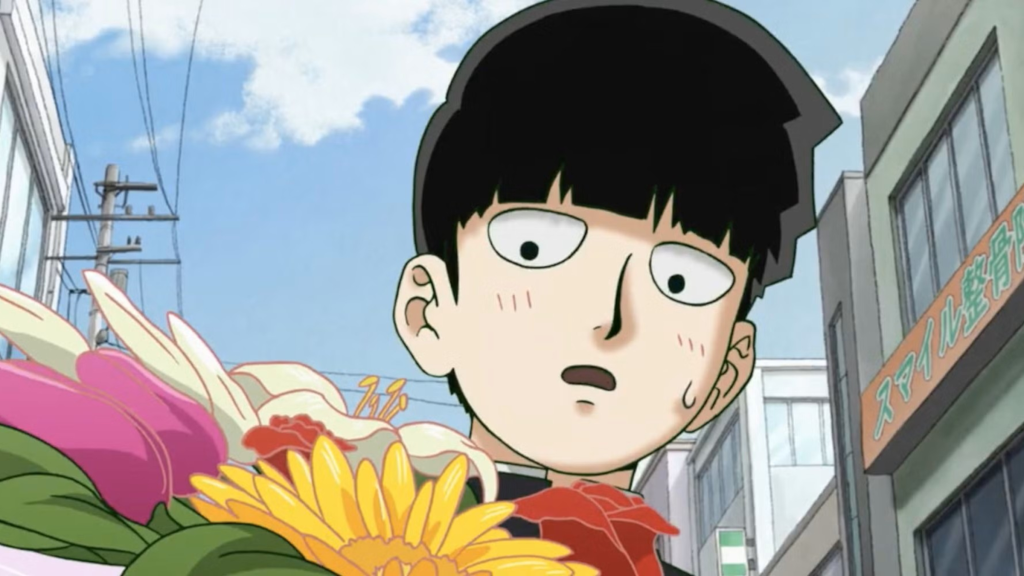 Shigeo looking down at flowers in Mob Psycho 100