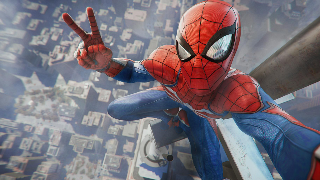 A screenshot from Marvel’s Spider-Man, showing Spider-Man atop a high building flashing a peace sign.
