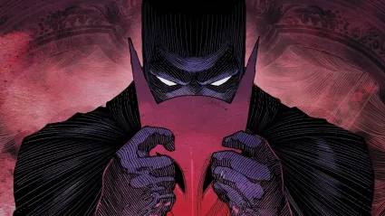 Batman holding a red mask near his face