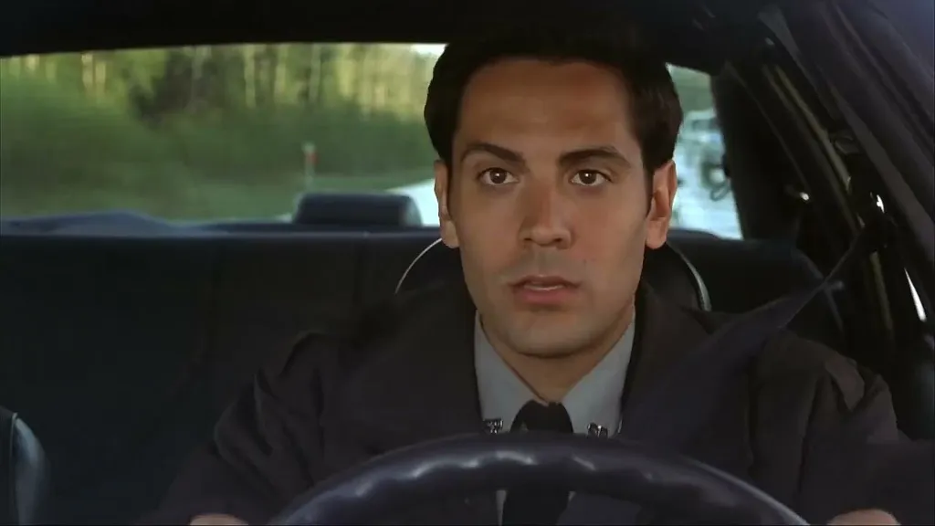 Thomas Burke shocked in front of the steering wheel in Final Destination 2