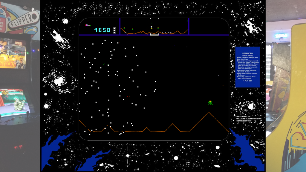 A screenshot from Defender with arcade bezel art over a picture of Retrovolt Arcade.