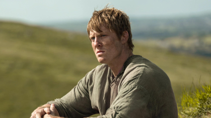 Dunk (Peter Claffey) in a field in A Knight of the Seven Kingdoms