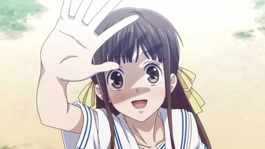 Tohru Honda holding up a hand and smiling in Fruits Basket (2019)
