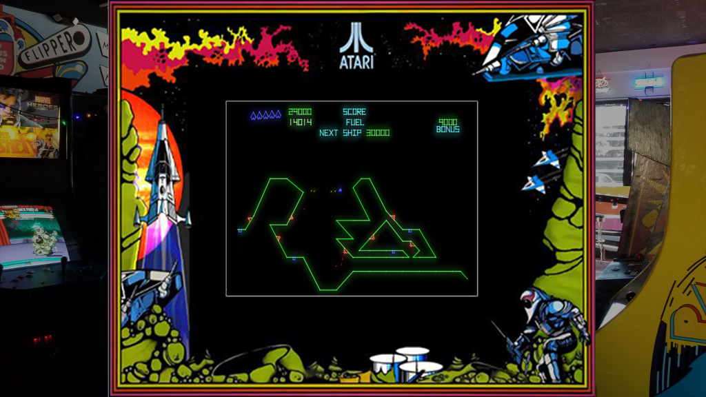 A screenshot from Gravitar with arcade bezel art over a picture of Retrovolt Arcade.