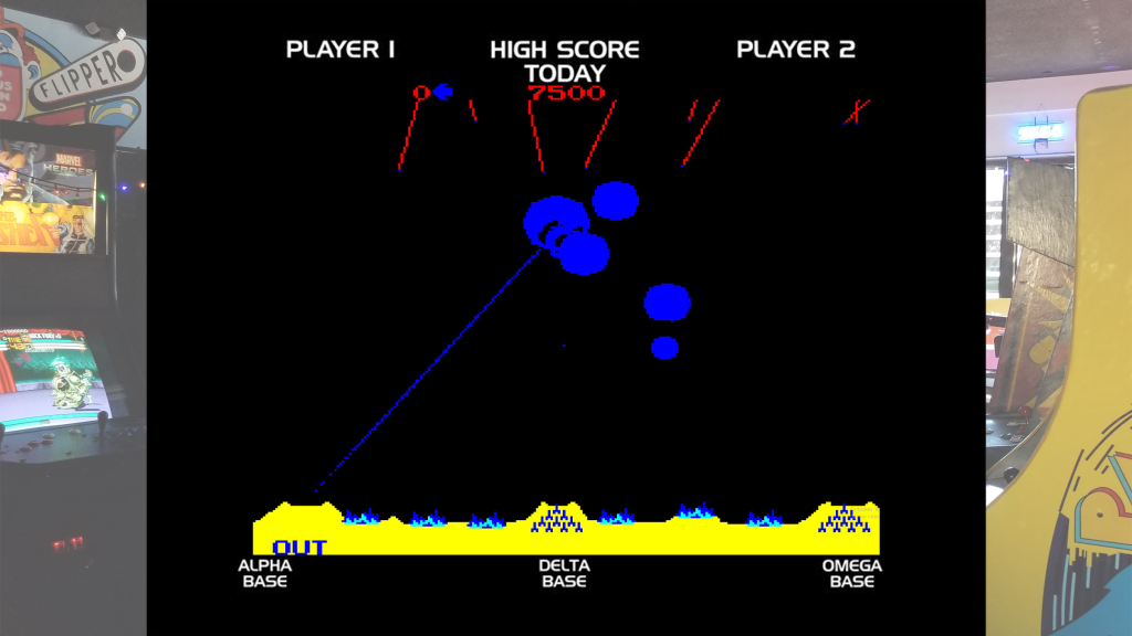 A screenshot from Missile Command and arcade bezel art over a picture of Retrovolt Arcade.