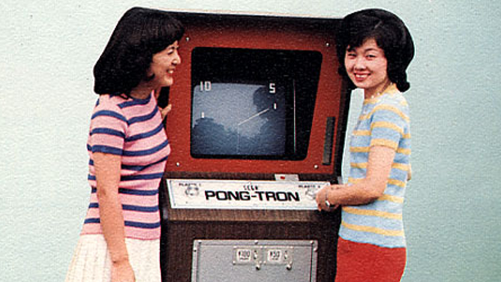 The arcade flying for Sega's Pong-Tron arcade cabinet, showing two women beside the cabinet.