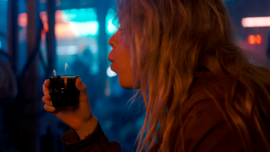 Kara (Milly Alcock) drinking in Supergirl